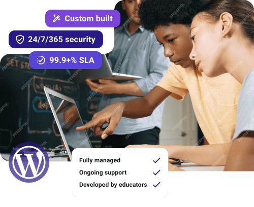 Children working and pointing at a laptop