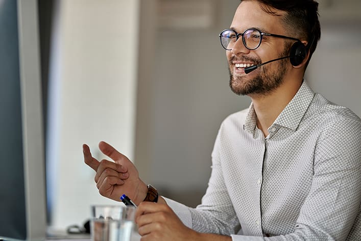 Office worker with headset smiling