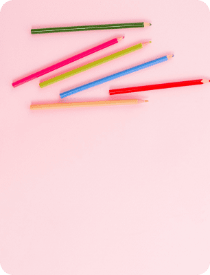 Colored pencils on a pink background